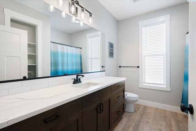 bathroom featuring vanity, hardwood / wood-style floors, and toilet