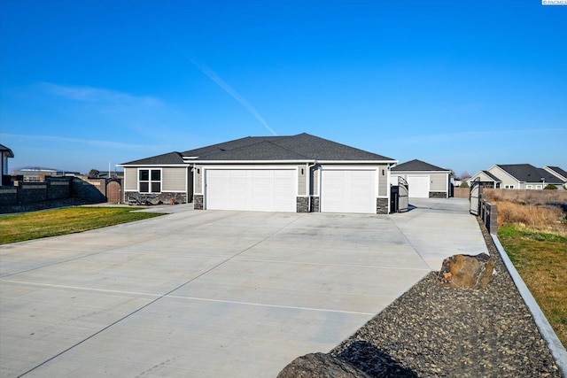 single story home featuring a garage and a front yard