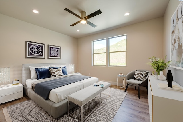 bedroom with ceiling fan and light hardwood / wood-style floors