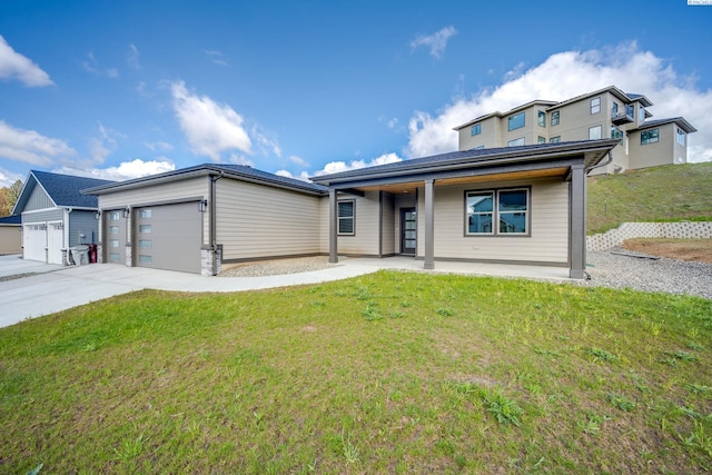 view of front of home featuring a garage and a front lawn