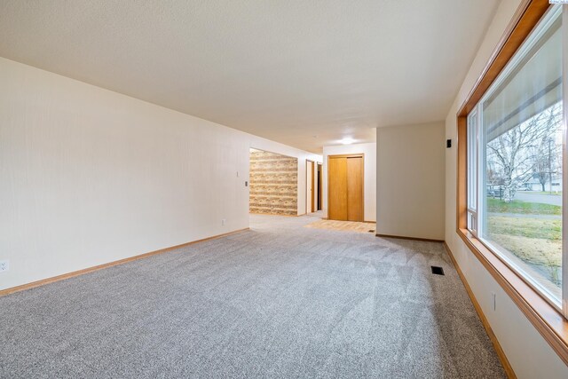 spare room featuring light colored carpet