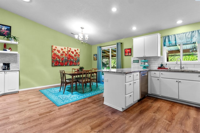 4500 S Dayton Ct, Kennewick, WA 99337 - kitchen with a sink, stainless steel dishwasher, a chandelier, white cabinets, and a peninsula