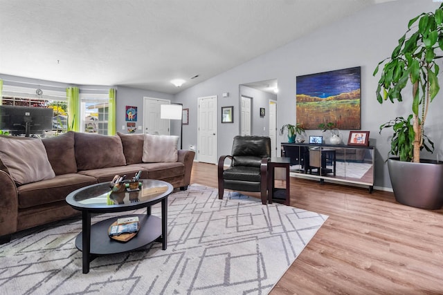 4500 S Dayton Ct, Kennewick, WA 99337 - living room featuring vaulted ceiling, wood finished floors, and baseboards