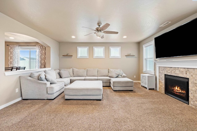 3011 S Dawes Pl, Kennewick, WA 99338 - carpeted living room with a ceiling fan, a fireplace, arched walkways, baseboards, and recessed lighting