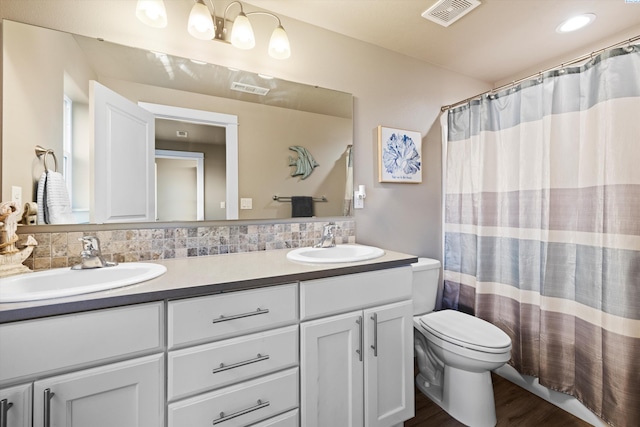 3011 S Dawes Pl, Kennewick, WA 99338 - bathroom featuring double vanity, toilet, wood finished floors, and curtained shower