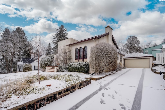 view of snow covered exterior featuring a garage