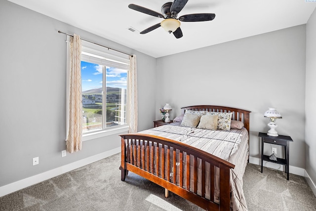 carpeted bedroom with baseboards and a ceiling fan