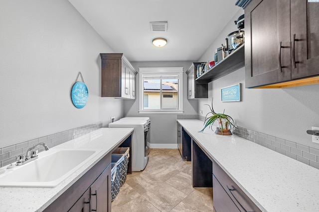laundry area with cabinet space, washing machine and dryer, and baseboards
