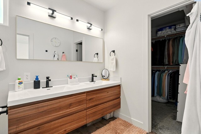 1006 Adams St, Richland, WA 99352 - bathroom with double vanity, baseboards, and a walk in closet