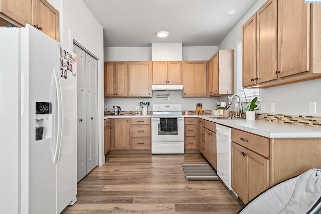 1006 Adams St, Richland, WA 99352 - kitchen with white appliances, a sink, under cabinet range hood, light countertops, and light wood-style floors