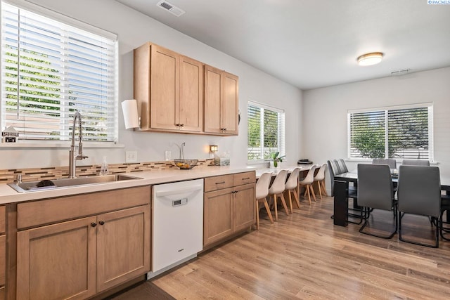 1006 Adams St, Richland, WA 99352 - kitchen featuring white dishwasher, a sink, light wood-type flooring, and light countertops