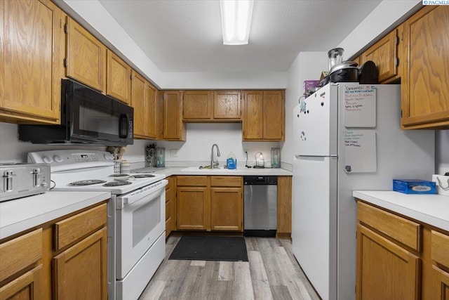 3121 W Hood Ave Unit E103, Kennewick, WA 99336 - kitchen with white appliances, light countertops, light wood-style floors, and brown cabinets