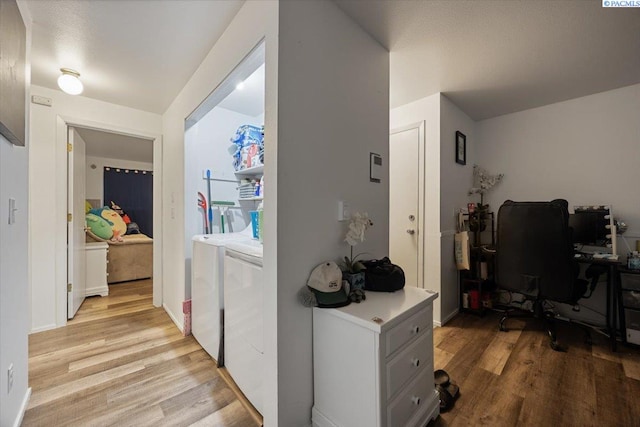 3121 W Hood Ave Unit E103, Kennewick, WA 99336 - hallway featuring washing machine and clothes dryer, light wood-style flooring, and a desk