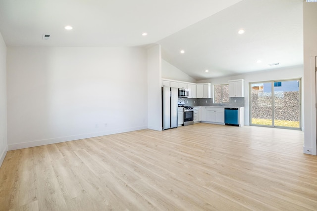 2967 S Penn St, Kennewick, WA 99338 - unfurnished living room with light wood finished floors, lofted ceiling, baseboards, recessed lighting, and a sink