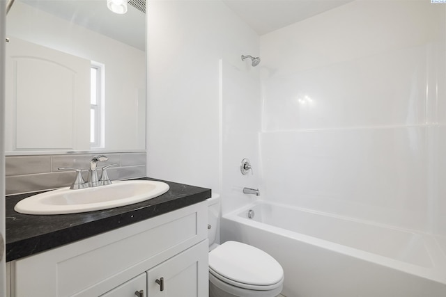 2967 S Penn St, Kennewick, WA 99338 - full bath with toilet, vanity, tub / shower combination, and tasteful backsplash