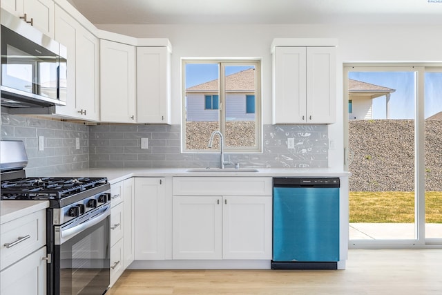 2967 S Penn St, Kennewick, WA 99338 - kitchen featuring stainless steel appliances, a sink, light countertops, and white cabinets
