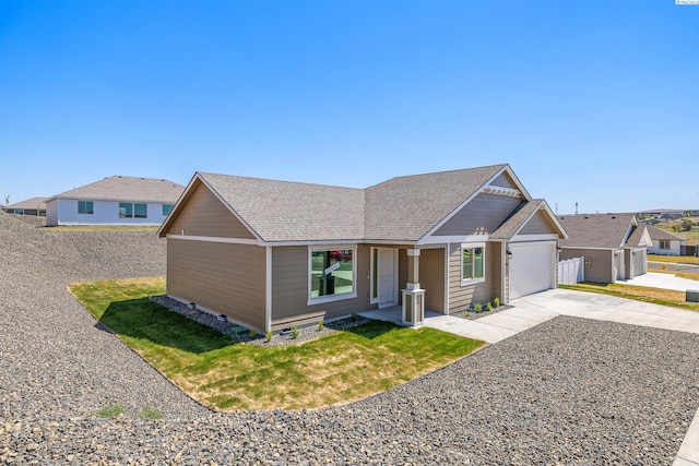 2967 S Penn St, Kennewick, WA 99338 - ranch-style house with driveway, a garage, a front lawn, and a shingled roof