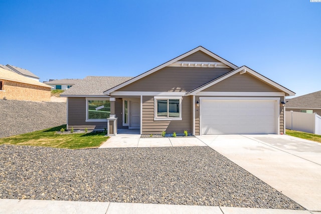 2967 S Penn St, Kennewick, WA 99338 - view of front of property featuring a garage, fence, and concrete driveway