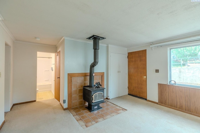 living room with light colored carpet, ornamental molding, and a wood stove