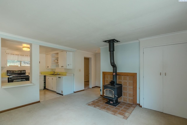 unfurnished living room featuring sink, crown molding, light colored carpet, and a wood stove