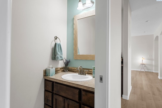 6013 Somerset Ln, Pasco, WA 99301 - bathroom featuring vanity, wood finished floors, and baseboards
