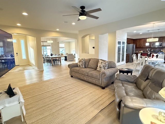 6013 Somerset Ln, Pasco, WA 99301 - living area featuring arched walkways, recessed lighting, ceiling fan, and light wood-style floors