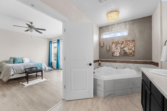 6013 Somerset Ln, Pasco, WA 99301 - ensuite bathroom with a garden tub, vanity, ceiling fan, and a chandelier