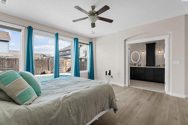 6013 Somerset Ln, Pasco, WA 99301 - bedroom featuring light wood-style floors, baseboards, connected bathroom, access to exterior, and ceiling fan
