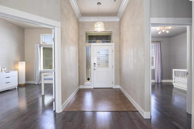 3512 El Paso Dr, Pasco, WA 99301 - foyer entrance featuring crown molding, baseboards, a chandelier, and dark wood-style flooring