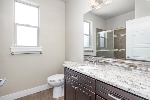3512 El Paso Dr, Pasco, WA 99301 - bathroom with toilet, vanity, tiled shower, tile patterned floors, and baseboards