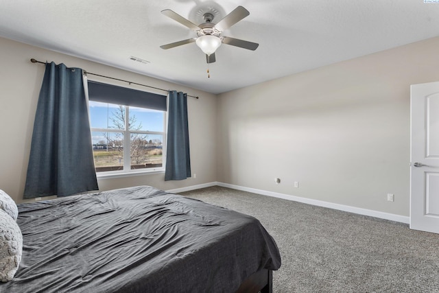 carpeted bedroom featuring visible vents, a ceiling fan, and baseboards