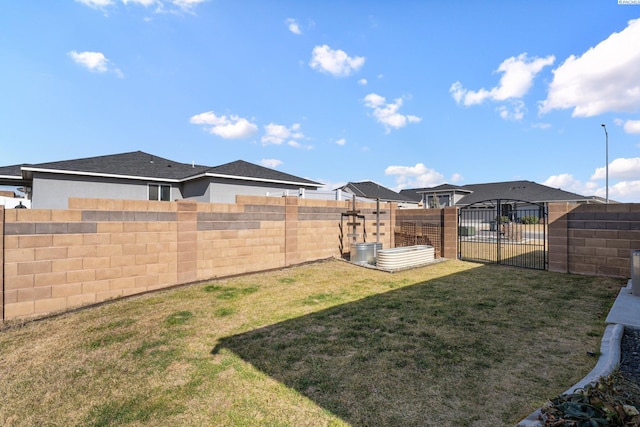 view of yard featuring a gate and a fenced backyard