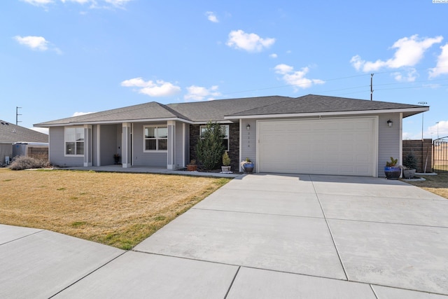 ranch-style home featuring a front lawn, fence, central AC unit, a garage, and driveway