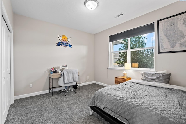 bedroom featuring a closet, visible vents, carpet flooring, and baseboards