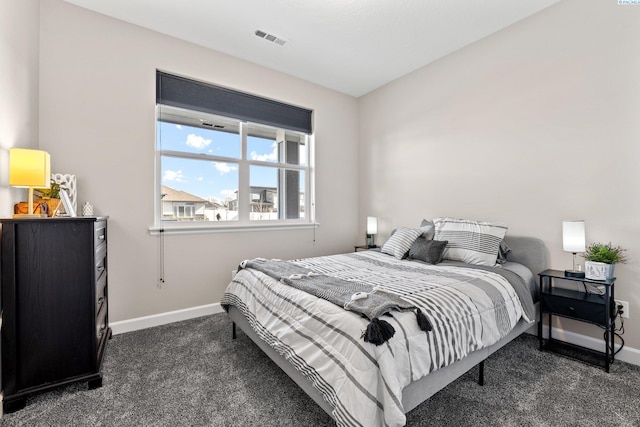 bedroom with visible vents, dark carpet, and baseboards