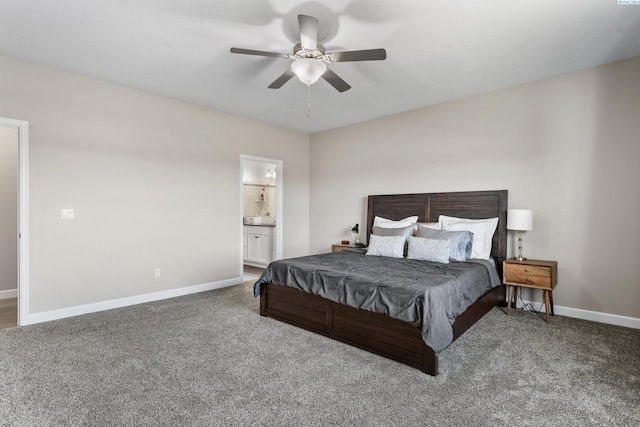 carpeted bedroom with baseboards, ensuite bath, and a ceiling fan