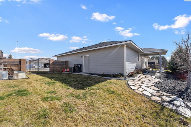 view of side of property with a lawn and fence