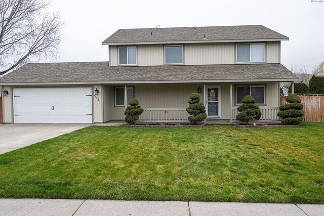 view of front of house featuring a garage and a front lawn