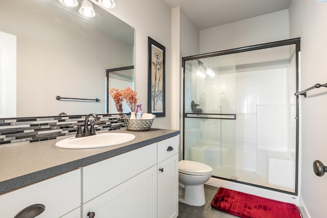 6416 Recurve Rd, Pasco, WA 99301 - bathroom with decorative backsplash, toilet, a stall shower, and vanity