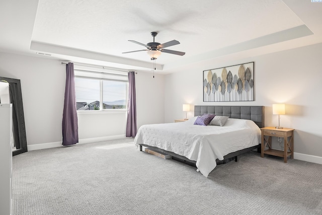 6416 Recurve Rd, Pasco, WA 99301 - carpeted bedroom featuring a raised ceiling, baseboards, and ceiling fan