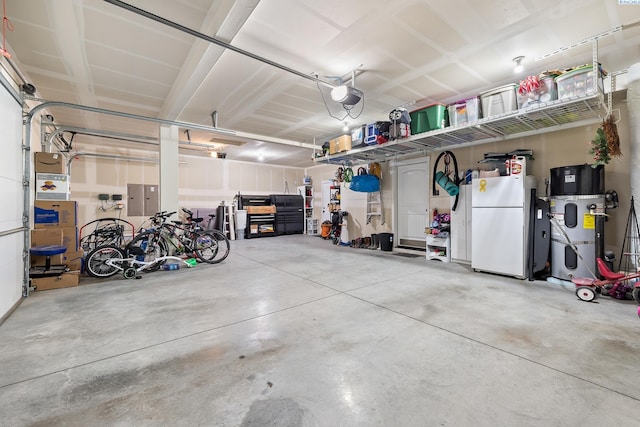 6416 Recurve Rd, Pasco, WA 99301 - garage featuring freestanding refrigerator, a garage door opener, and electric panel