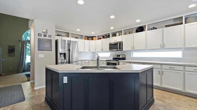 5405 Warbler Ln, West Richland, WA 99353 - kitchen with appliances with stainless steel finishes, light countertops, a center island with sink, backsplash, and recessed lighting