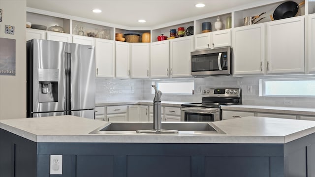 5405 Warbler Ln, West Richland, WA 99353 - kitchen with appliances with stainless steel finishes, light countertops, decorative backsplash, white cabinets, and recessed lighting