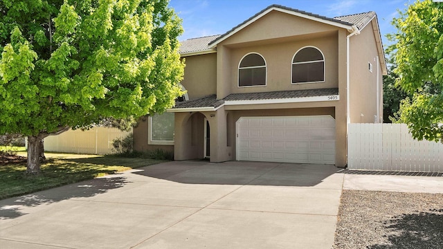 5405 Warbler Ln, West Richland, WA 99353 - view of front of home with an attached garage, concrete driveway, stucco siding, and a tiled roof