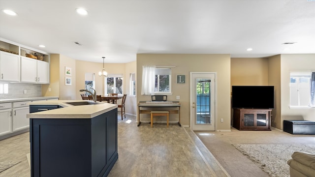 5405 Warbler Ln, West Richland, WA 99353 - kitchen featuring open floor plan, white cabinetry, light countertops, an island with sink, and recessed lighting