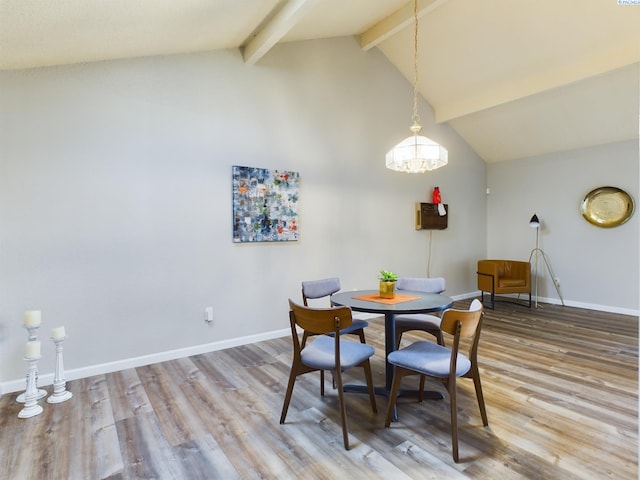 dining room with hardwood / wood-style floors and vaulted ceiling with beams