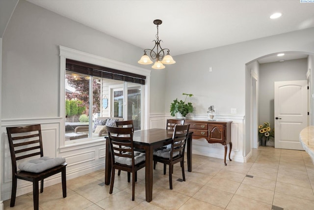 1010 Christopher Ln, Pasco, WA 99301 - dining room featuring arched walkways, a decorative wall, a wainscoted wall, recessed lighting, and light tile patterned floors