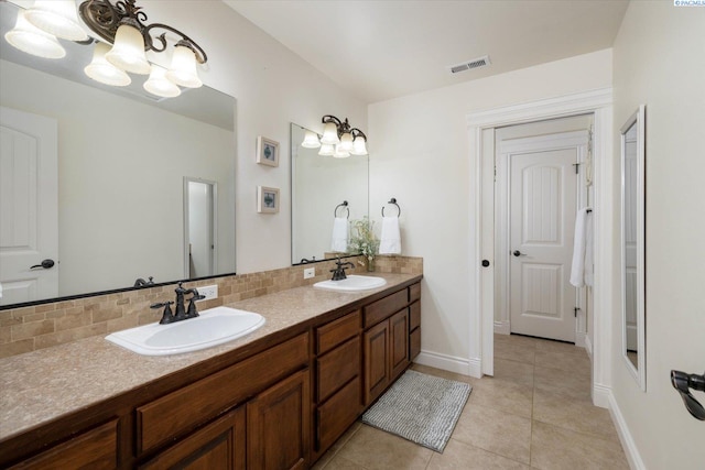 1010 Christopher Ln, Pasco, WA 99301 - bathroom featuring a chandelier, double vanity, backsplash, and tile patterned flooring