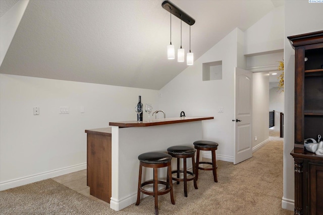 1010 Christopher Ln, Pasco, WA 99301 - indoor wet bar with lofted ceiling, light colored carpet, baseboards, and decorative light fixtures