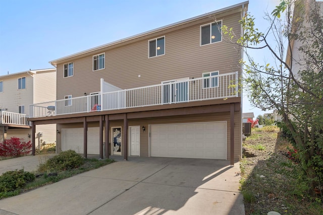 rear view of property with a garage and central air condition unit